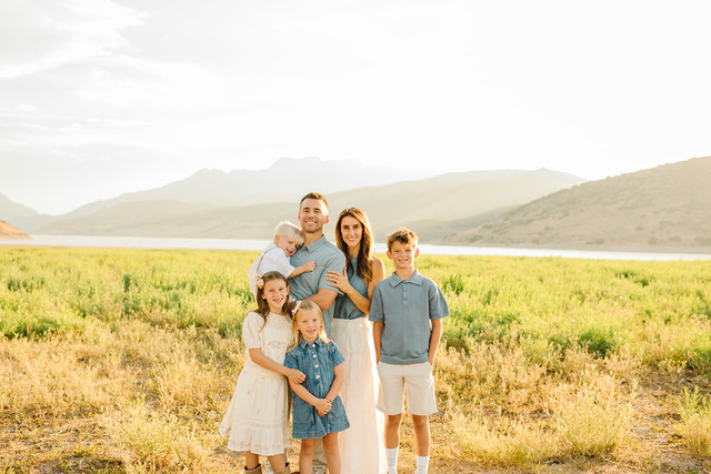 The Hunsaker family smiling outdoors in Lehi, Utah